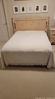 White chenille bedspread with geometric pattern and fringe spread on bed