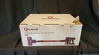 Box of NEQUARE handheld cordless vacuum cleaner model 6128, front view showing product image and branding