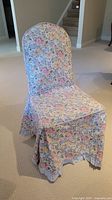 Front view of chair covered with Laura Ashley floral cotton fabric cover with ruffled skirt.
