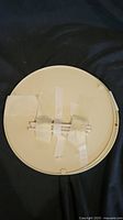 Bottom of beige circular Lazy Susan part with taped rotary mechanism