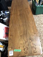 Photo showing the full length and wood grain surface of the coffee table with labeling of dimensions.