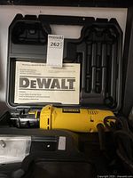 DeWalt DW660 cut-out tool and manual inside the molded plastic carrying case