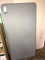 Top view of the light gray folding table, showing the smooth surface and rounded corners.