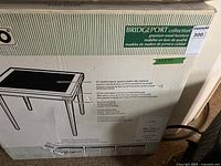 Original box of Bridgeport Collection folding table showing product specifications and dimensions 32x29 inches, with visible box damage noted in seller description.