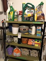 Full shelf with garden chemical products on top shelf, various plant pots on middle shelves, decorative wind chime, and insecticide box.