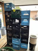 Three stacks of crates against garage opening showing left, middle, right stacks