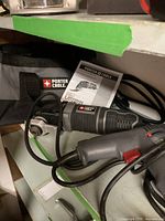 Photo of Porter Cable multi-tool with instruction manual and carrying bag showing brand and tool condition.