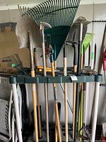 Full view of Rubbermaid organizer rack holding multiple garden tools