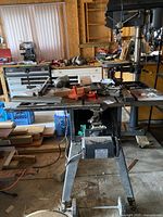 Full view of Sears Craftsman table saw showing work surface, orange blade insert, motor mounted underneath, and metal stand.