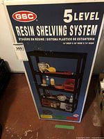 Front view of the shelving system box showing brand (GSC), 5 level resin shelving system with dimensions 14" deep x 36" wide x 74" high