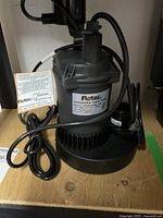 Front and side view showing pump body, power cord and labels.