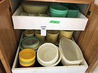 Drawers with multiple plastic bowls, nested containers, and ventilated yellow containers