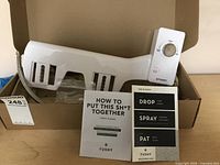 Tushy Classic bidet attachment laid out in open packaging with instructions visible
