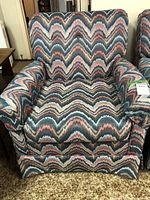 Front view of the armchair showing the full zig zag upholstery pattern and shape.