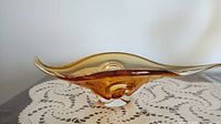 Side angle showing the full curved organic form and amber coloring.