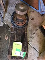 Overall angled view of the sharpener showing the grinding wheel, motor, and wooden base.