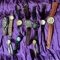 Full view of ten assorted watches laid in a row showing different bands and watch faces including themed and brand-name watches