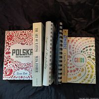 Front cover view of 5 cookbooks arranged side by side showing titles and bindings.