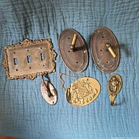 Full lot of six brass items on blue quilted background