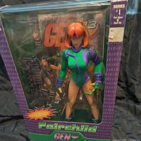 Front view of unopened Fairchild action figure in original packaging with accessories and comic book visible.