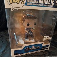 Front view of the Hawkeye Funko Pop figure in its original display box, showing clear packaging and figure inside.