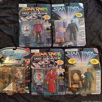 Front view of five Star Trek action figures in sealed original packaging showing characters and accessories clearly.