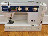 Front view of Elna SU Air Electronic 68 sewing machine showing stitch selector dials and chart