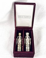 Nutcracker salt and pepper shakers presented in original velvet-lined Silver Gallery case; shakers positioned side by side.
