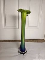 Front view of tall Murano glass vase with clear base and color gradient