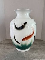 Full front view of vase showing body shape and koi fish decoration