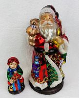 Front view of both Santa Claus and boy blown glass figures showing detailed colors and design