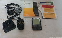 BlackBerry device, charging dock, cables, and paper manuals arranged on floor