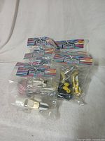 Photo showing 8 Power Rangers action figures individually sealed in original packaging from McDonald's including the colorful branded cards and bags.