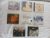 All 8 Radiohead CDs laid out on a white surface showing cover art for identification.