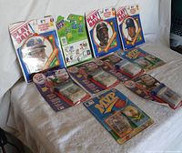 Overview of all 10 original baseball trading card packages laid out on a white cloth background showing variety in packaging and series.