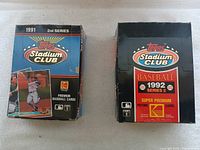 Two unopened unopened Topps Stadium Club baseball card boxes from 1991 2nd series and 1992 series 2 showing front designs and branding.