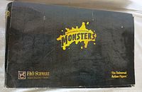 Photo of original outer packaging box, showing black box with Universal Studios Monsters logo and FAO Schwarz branding, box condition is poor with visible wear and creasing.