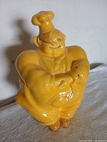 Front view of yellow ceramic cookie jar shaped as a chef by Redwing, showing full body and overall shape.