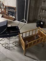 Overall setting showing both the navy doll buggy and wooden doll cradle on wheels with bunny bank inside.