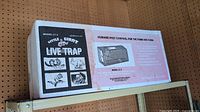 Box packaging showing illustrations and model information for the Model LT3 live trap designed for humane small animal capture.