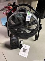 View of Patton industrial fan alongside small Airworks heater and heater manual on a floor surface.