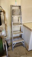 Full view of aluminum step ladder showing overall condition and height