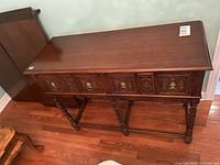 Front view showing carved wooden front, two drawers, and barley twist legs