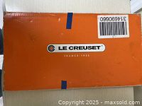 Photo of an orange box with the Le Creuset logo and France 1925 printed below it, showing the brand packaging.