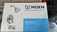 Box front showing Moen logo and Banbury 82910 model with chrome finish details and product image.