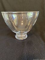 Side view of the large clear glass bowl showing curved body and footed base