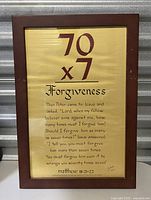 Full view of framed print with Bible verse about forgiveness, numbers 70 x 7 at top and text from Matthew 18:21-22 below.