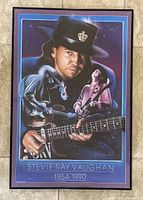 Frontal view of the Stevie Ray Vaughan framed poster showing the full subject and blue-purple bordering.