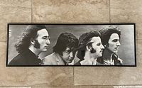Full view of the framed poster showing all four Beatles members in side profile.