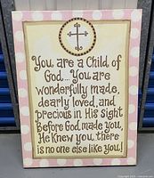 Single rectangular wall art piece featuring an inspirational religious quote with a cross emblem on top, beige background with light pink and white polka dot border.